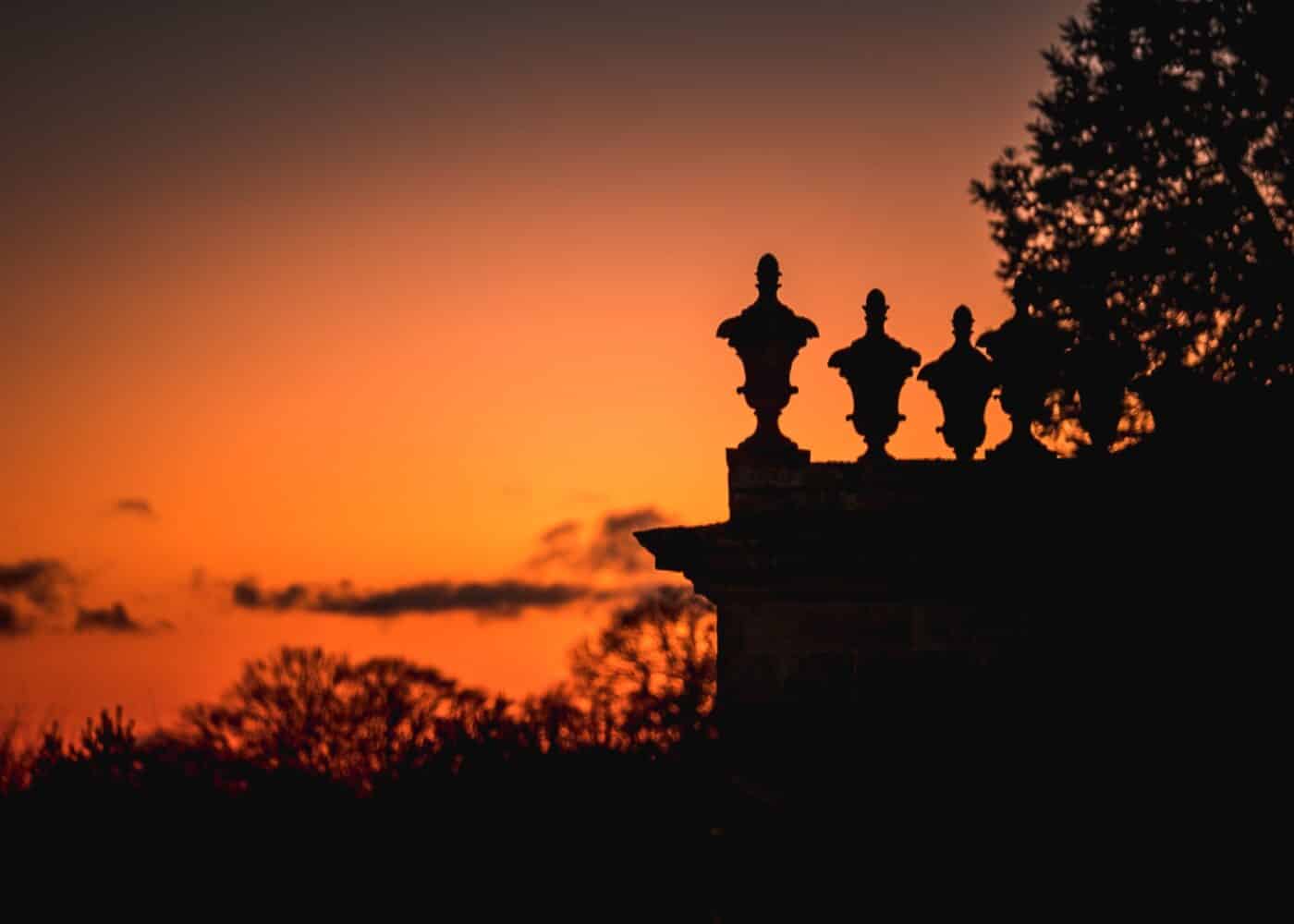 urns on roof at sunset